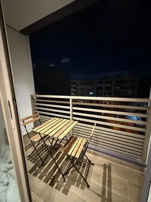 a balcony with a table and chairs on a balcony at Cozy and chic apartment in Casablanca in Casablanca