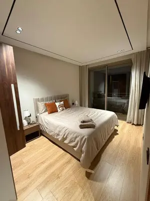 a bedroom with a bed and a large window at Cozy and chic apartment in Casablanca in Casablanca