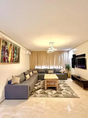 a living room with a couch and a table at Modern studio in Burgundy in Casablanca-Port