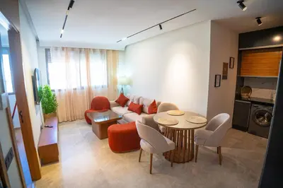 a living room with a couch and a table and chairs at KeyLiving 501 3 pers Emplacement Top Wifi in Casablanca