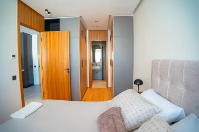 a bedroom with a white bed and a bathroom at KeyLiving 501 3 pers Emplacement Top Wifi in Casablanca
