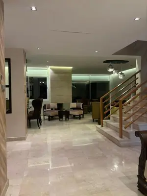 a lobby with a staircase and a living room at Villa de luxe CGI avec piscine in Bouskoura