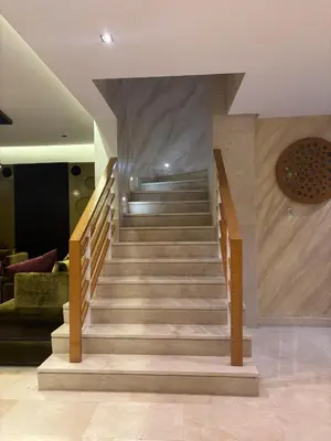 a staircase in a lobby with a stair case at Villa de luxe CGI avec piscine in Bouskoura