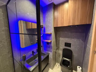 a bathroom with a sink and a toilet with blue lights at CityZen in Casablanca