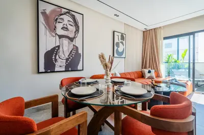 a dining room with a table and orange chairs at CFC business, Coworking, gym, self check-in in Casablanca
