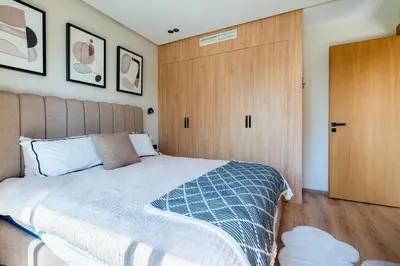 a bedroom with a bed and a wooden door at CFC business, Coworking, gym, self check-in in Casablanca