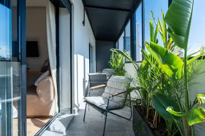 a balcony with chairs and plants on a building at CFC business, Coworking, gym, self check-in in Casablanca
