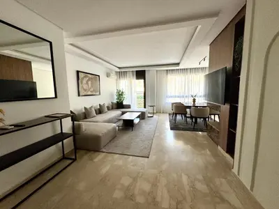 a living room with a couch and a table at CityZen Suites, Luxury 3BR near Mohamed V Stadium in Maarif