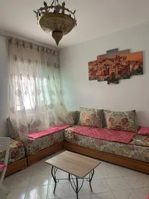 a living room with a couch and a table at Appartement cosy à Rabat Mer et commodités à pied in Rabat