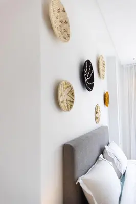 a bedroom with a bed and plates on the wall at APGCI -Studio Élégant a 5 min du Stade Mohamed V in Casablanca