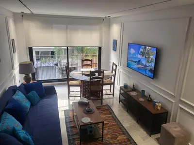 a living room with a blue couch and a table at O'Blu Pearl Casablanca Center, Morocco in Casablanca
