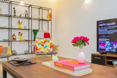 a table with books and a vase of flowers on it at Luxury central Apartment - 3BR - Flipper - Parking in Casablanca