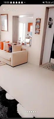 a living room with two couches and a mirror at Appartement à louer Aux perles de tamaris in Tamaris