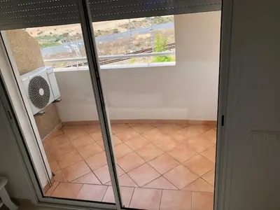 an empty room with a window and a tiled floor at Superbe Appartement à Louer C14 Jnane Dalya in Bouznika