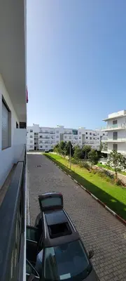 a car parked on a street next to a building at appartement luxe dt3 in Mohammedia