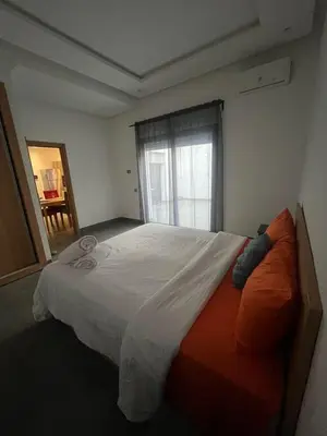 a bedroom with a large bed and a window at Appart hôtel las jemelas in Casablanca