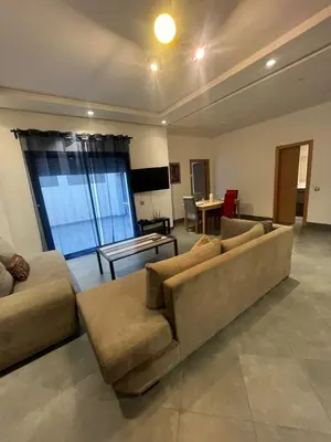 a living room with a couch and a table at Appart hôtel las jemelas in Casablanca
