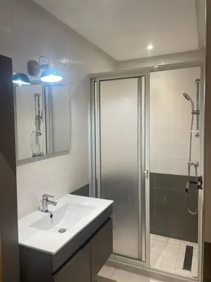 a bathroom with a white sink and a shower at Appart hôtel las jemelas in Casablanca