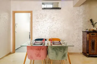 a dining room with a glass table and chairs at 2ch au Centre de Mohammedia Parc in Mohammedia