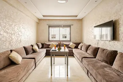 a living room with a large couch and a table at 2ch au Centre de Mohammedia Parc in Mohammedia