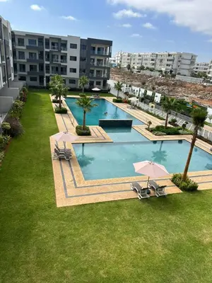 an overhead view of a pool with chairs and an umbrella at 3 bedrooms in El Mansouria with pool beach terrace in Pont Blondin