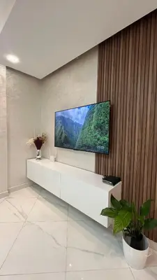 a living room with a flat screen tv on a wall at Appartement Moderne et Lumineux in Rabat