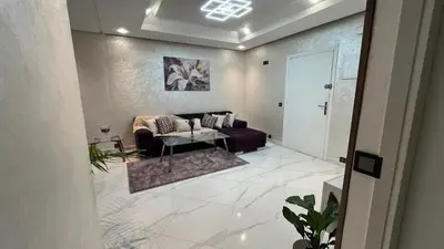 a living room with a couch and a table at Appartement Moderne et Lumineux in Rabat