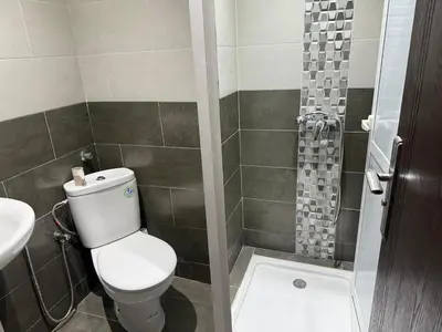 a bathroom with a toilet and a shower at Modern apartment in Rabat, Temara in Temara