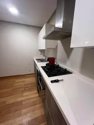 a kitchen with a stove and a white counter top at Stunning Marina high floor ocean view in Casablanca