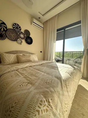 a bedroom with a large bed and a large window at Bohemian Oasis in Casablanca
