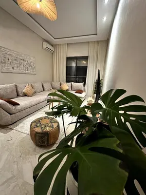 a living room with a couch and a plant at Bohemian Oasis in Casablanca