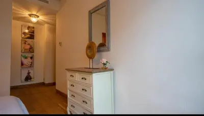 a bedroom with a dresser with a mirror on it at Cosy home in Casablanca