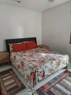 a bedroom with a bed with a floral comforter at Calme large studio in Casablanca