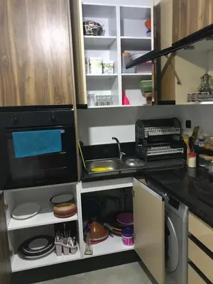 a kitchen with a sink and a microwave at appartement in Mohammedia