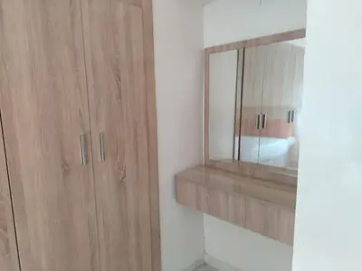 a bathroom with a wooden cabinet and a mirror at Très joli appartement à Casablanca in Casablanca