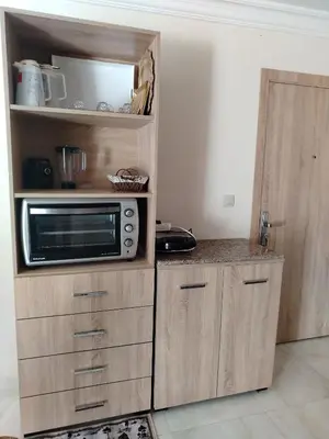 a kitchen with a microwave on top of a cabinet at Très joli appartement à Casablanca in Casablanca