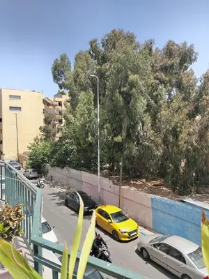 a yellow car is parked on a street with cars at Très joli appartement à Casablanca in Casablanca