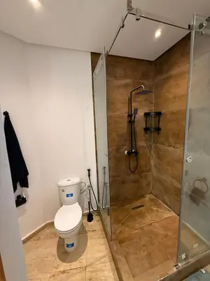 a bathroom with a toilet and a shower at Modern Studio in Hay Riad All Comfort in Rabat