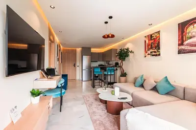 a living room with a couch and a table at Appartement Cosy neuf - Salle de sport in Casablanca