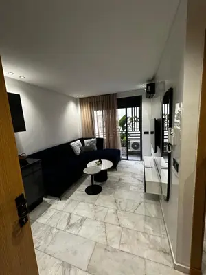 a living room with a couch and a table at Luxury studio Maarif à 5 min CFC in Casablanca