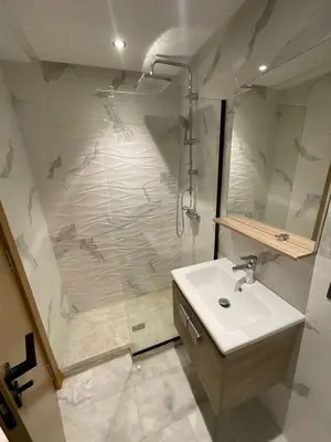 a bathroom with a shower and a white sink at Luxury studio Maarif à 5 min CFC in Casablanca