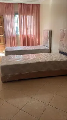 a bedroom with two beds and a window at Casa 2mars Appart lumineux in Casablanca