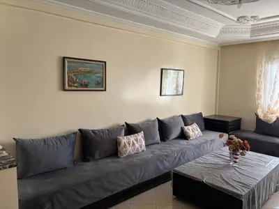 a living room with a gray couch and a table at Casa 2mars Appart lumineux in Casablanca