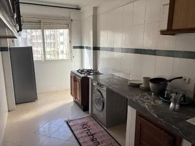 a kitchen with a stove and a dishwasher in it at Casa 2mars Appart lumineux in Casablanca