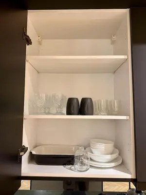 a cupboard filled with plates and bowls and dishes at Cozy Modern Studio Near Stadium Mohammed V in Casablanca