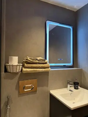 a bathroom with a sink and a tv on the wall at Cozy Modern Studio Near Stadium Mohammed V in Casablanca