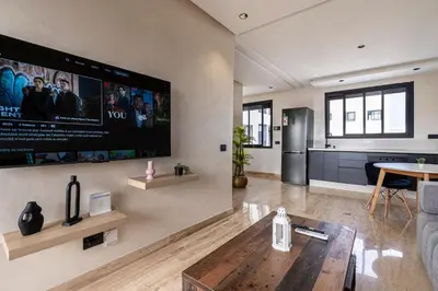 a living room with a large flat screen tv on the wall at New 8th floor Terrace 5 min from train stations in Casablanca