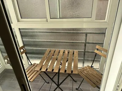 a porch with two chairs and a window at Apartamento Temara Morroco in Temara