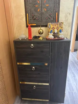 a black dresser with two drawers and stuffed animals on it at Apartamento Temara Morroco in Temara