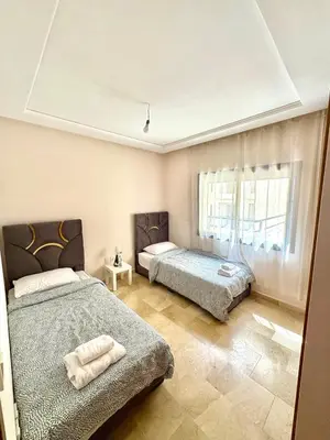 a bedroom with two beds and a window at Twin Center View Apt in Maarif in Maarif